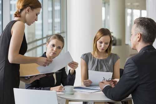 A health counselor hands out documents during a meeting